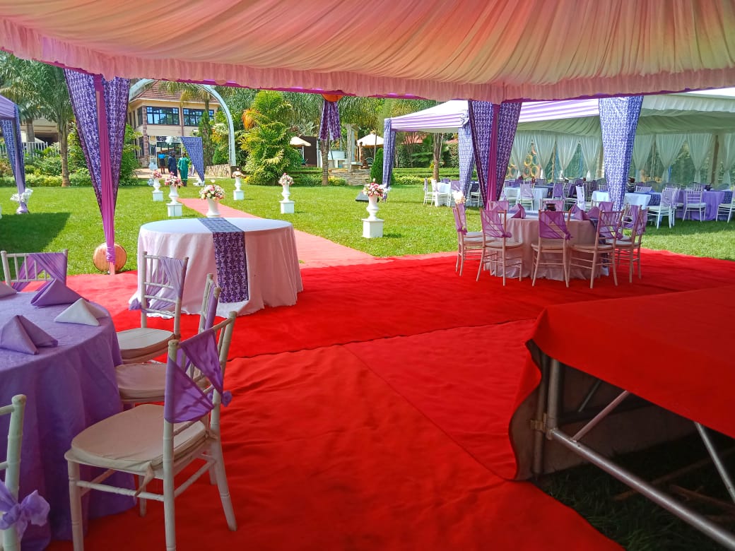 A beautifully decorated banquet hall with floral centerpieces and elegant table settings